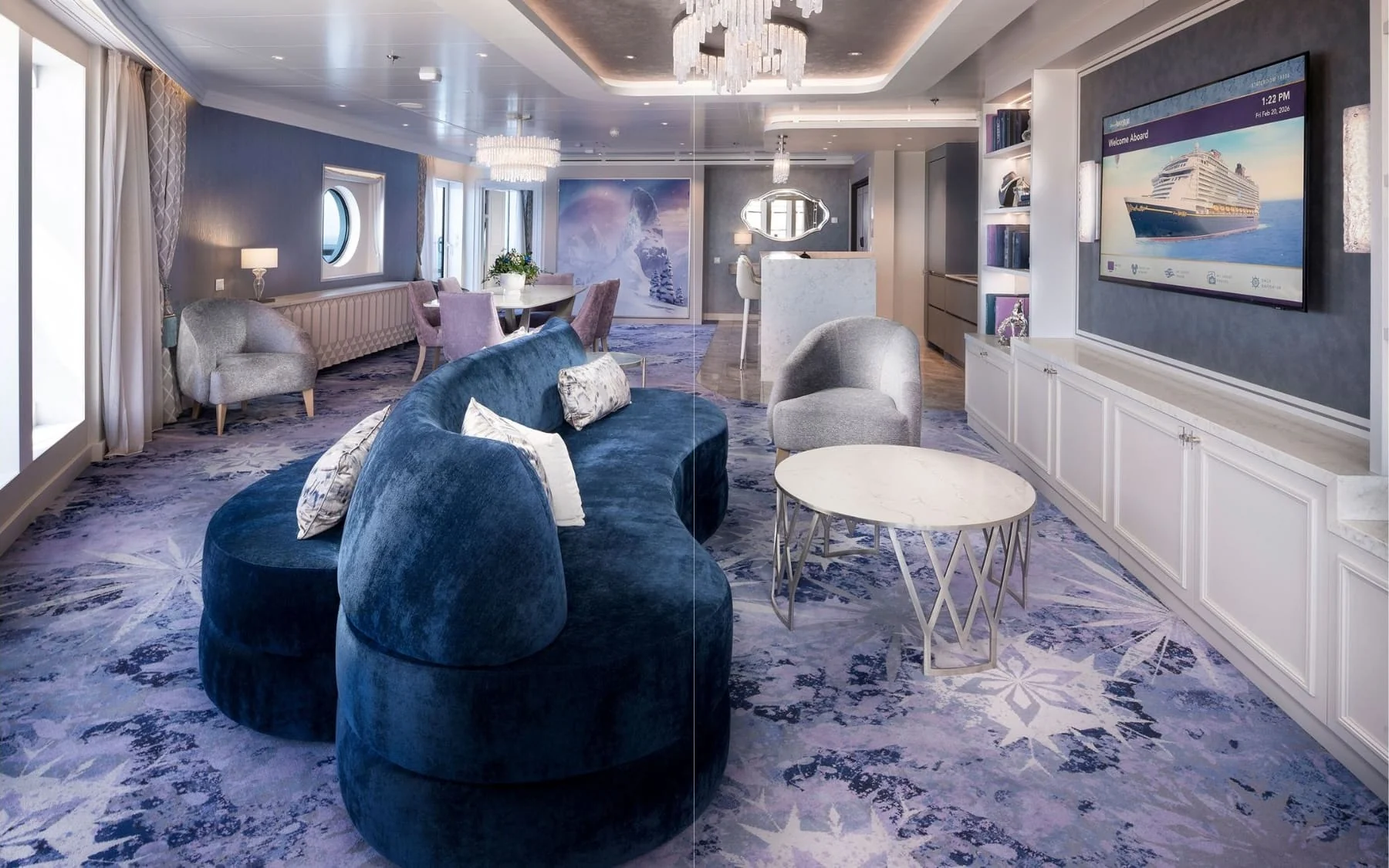 Frozen themed Concierge Royal Suite with blue velvet sofa crystal chandelier and snowflake carpet on Disney Adventure