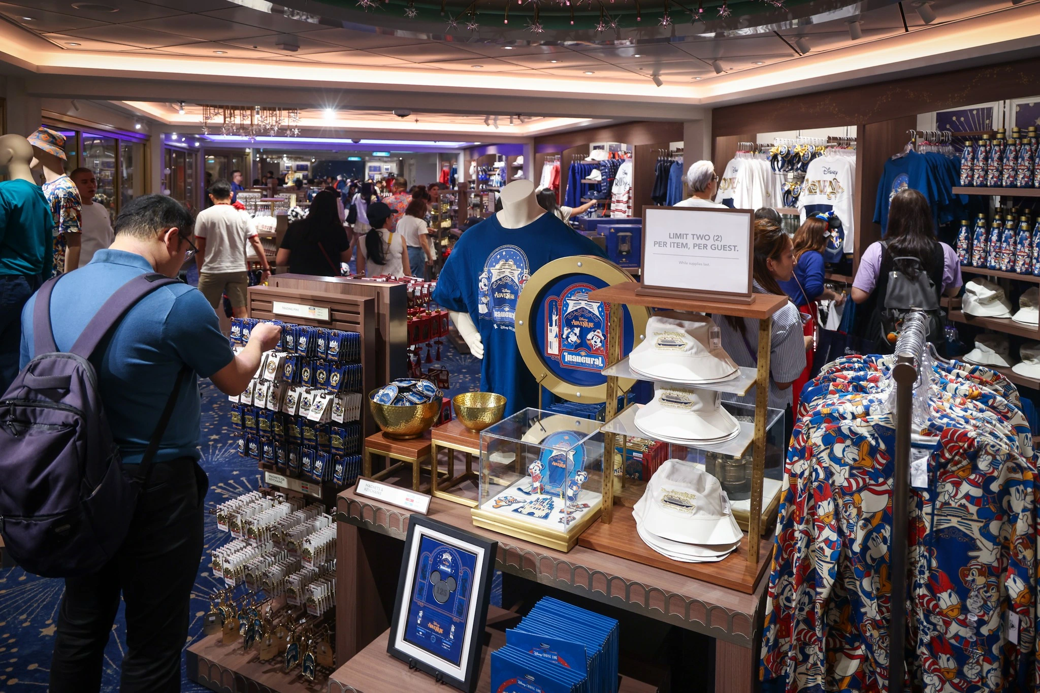 Disney Adventure onboard merchandise shop with inaugural voyage t-shirts pins hats and exclusive souvenirs