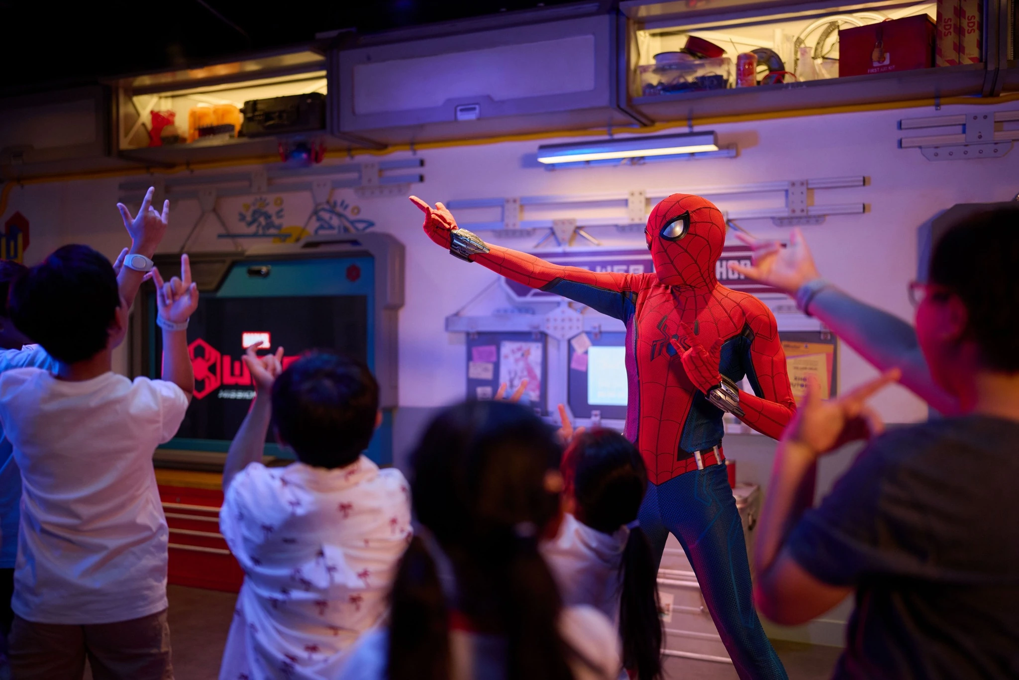 Spider-Man character meet and greet with kids doing web-slinging pose at Marvel Landing on Disney Adventure cruise