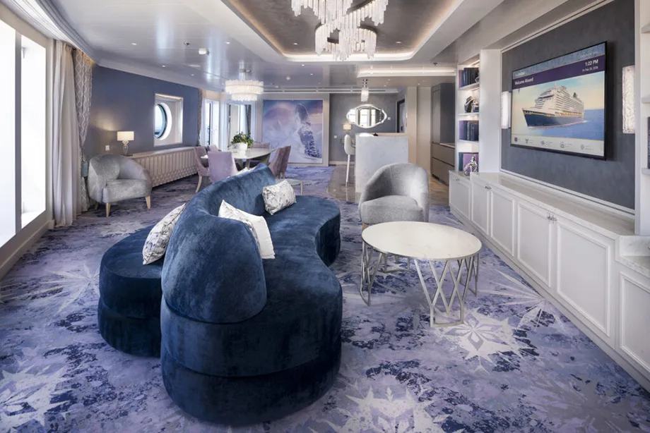 Elsa Royal Suite on the Disney Adventure — Frozen-themed luxury living room with blue velvet sofa and crystal chandelier