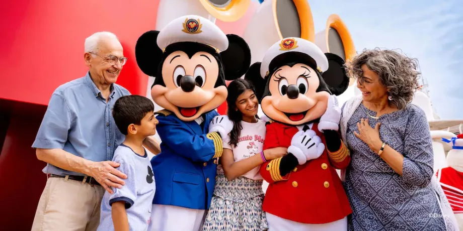 Indian family meeting Captain Mickey and Captain Minnie on the Disney cruise ship in Singapore.